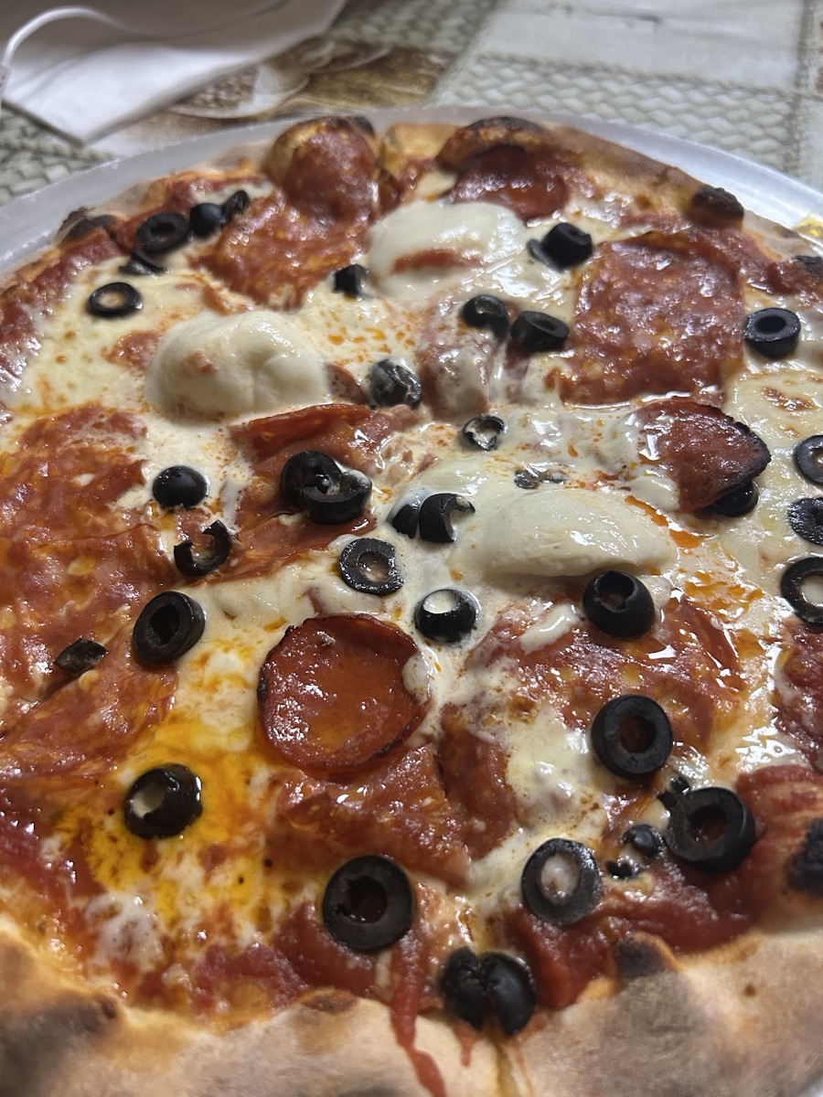 Pepperoni and olive pizza close-up at Italian Corner